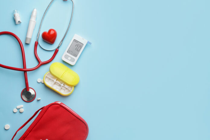 Glucometer with pills, stethoscope, lancet pen and heart on color background. Diabetes concept Glucometer with pills, stethoscope, lancet pen and heart on color background.